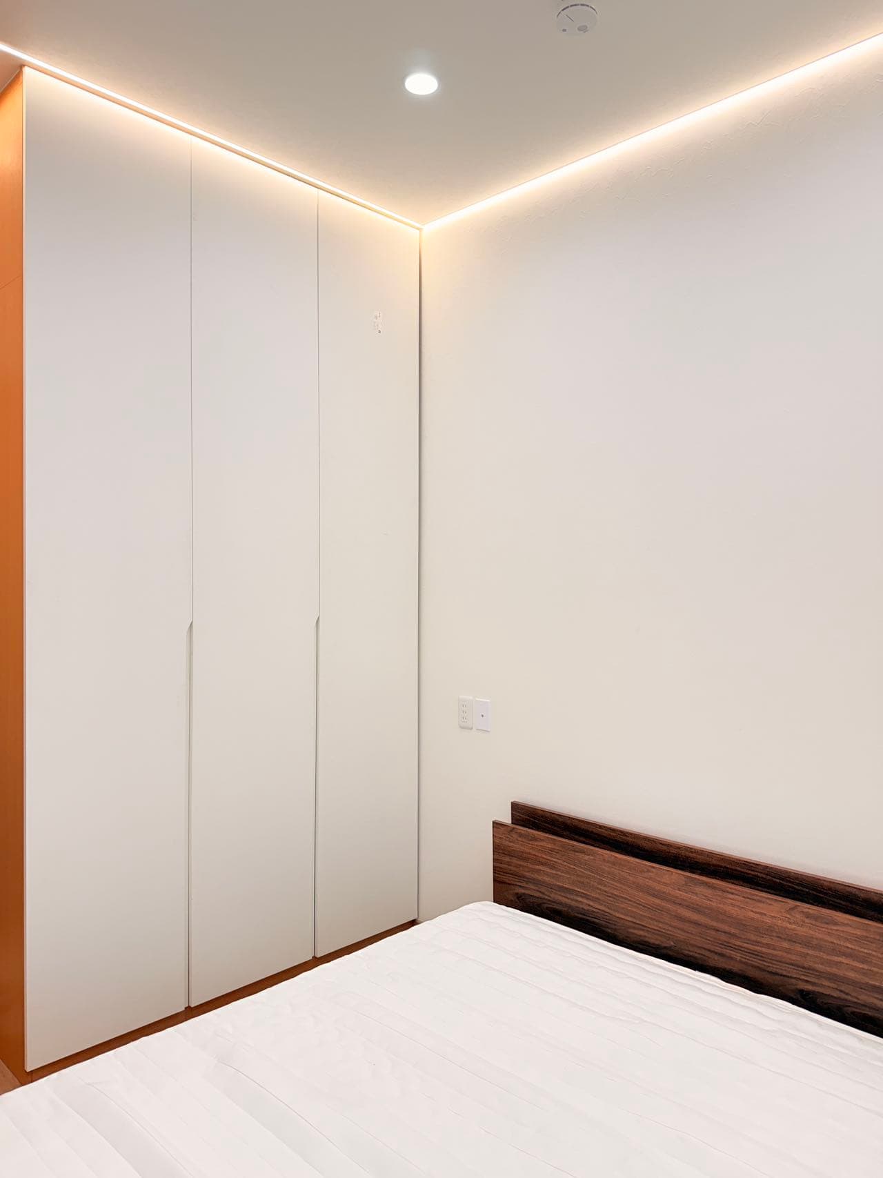 Bedroom storage wall and bed